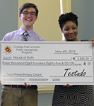 2 College Park Scholars hold check