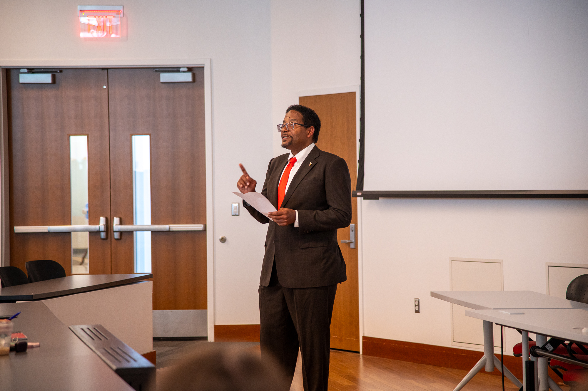 President Pines turned toward students in class