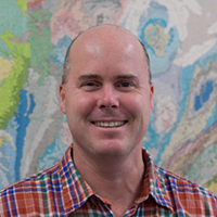 James Farquhar in front of map