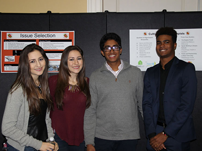 Four students in front of poster session presentation