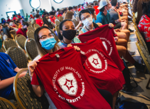 UH students hold up house t-shirts