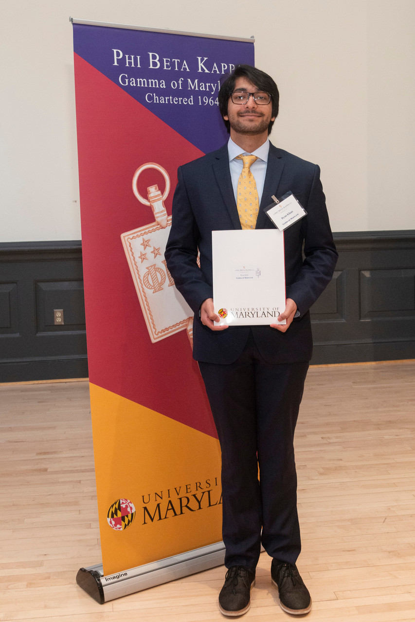 A new PBK inductee poses with their certificate