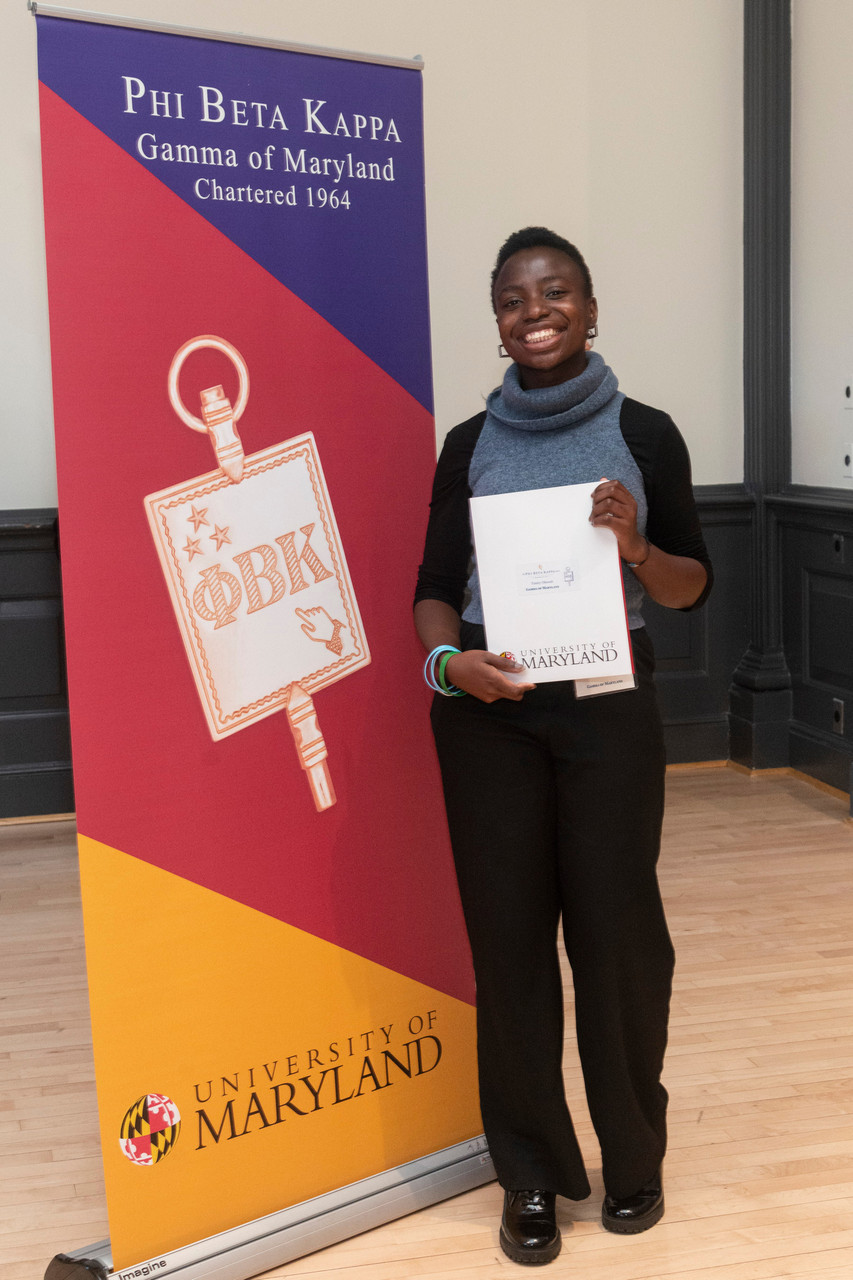 A newly inducted member poses with her certificate.