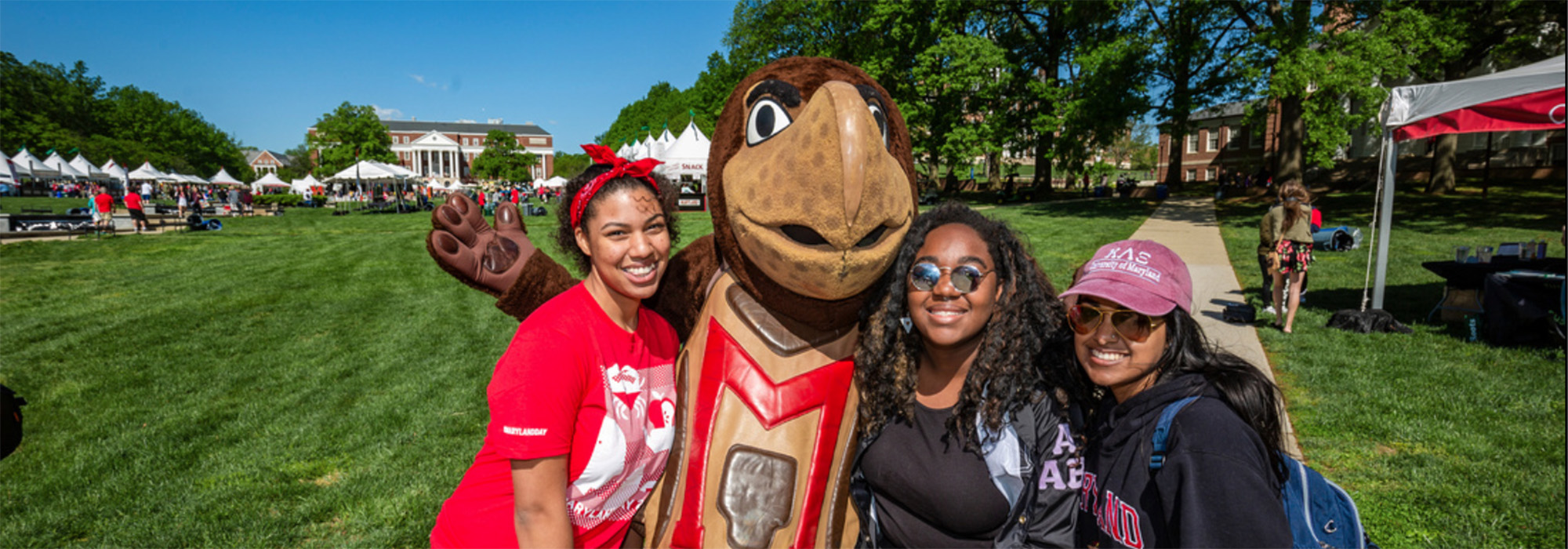Three students with the Testudo mascot